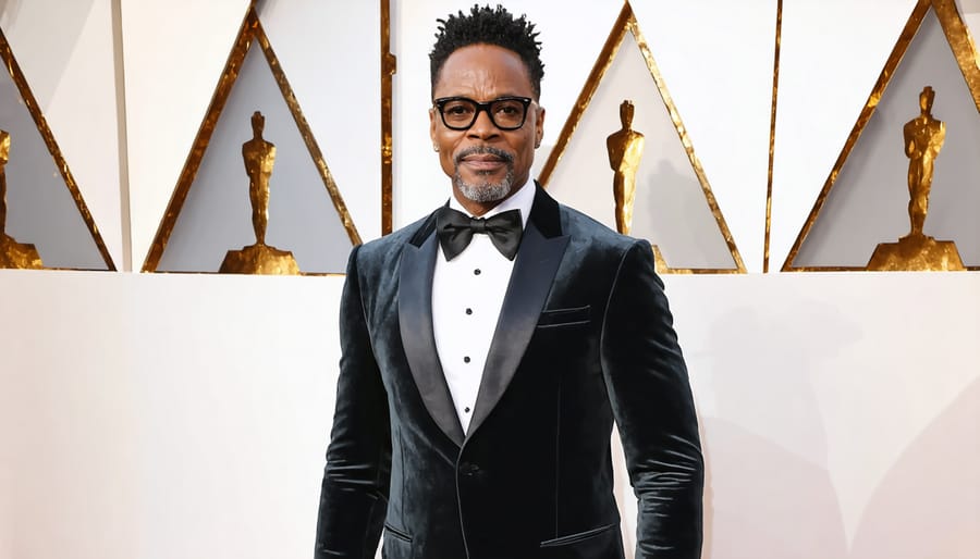 Billy Porter wearing a fitted black velvet tuxedo jacket with a full, flowing black skirt at the 2019 Oscars